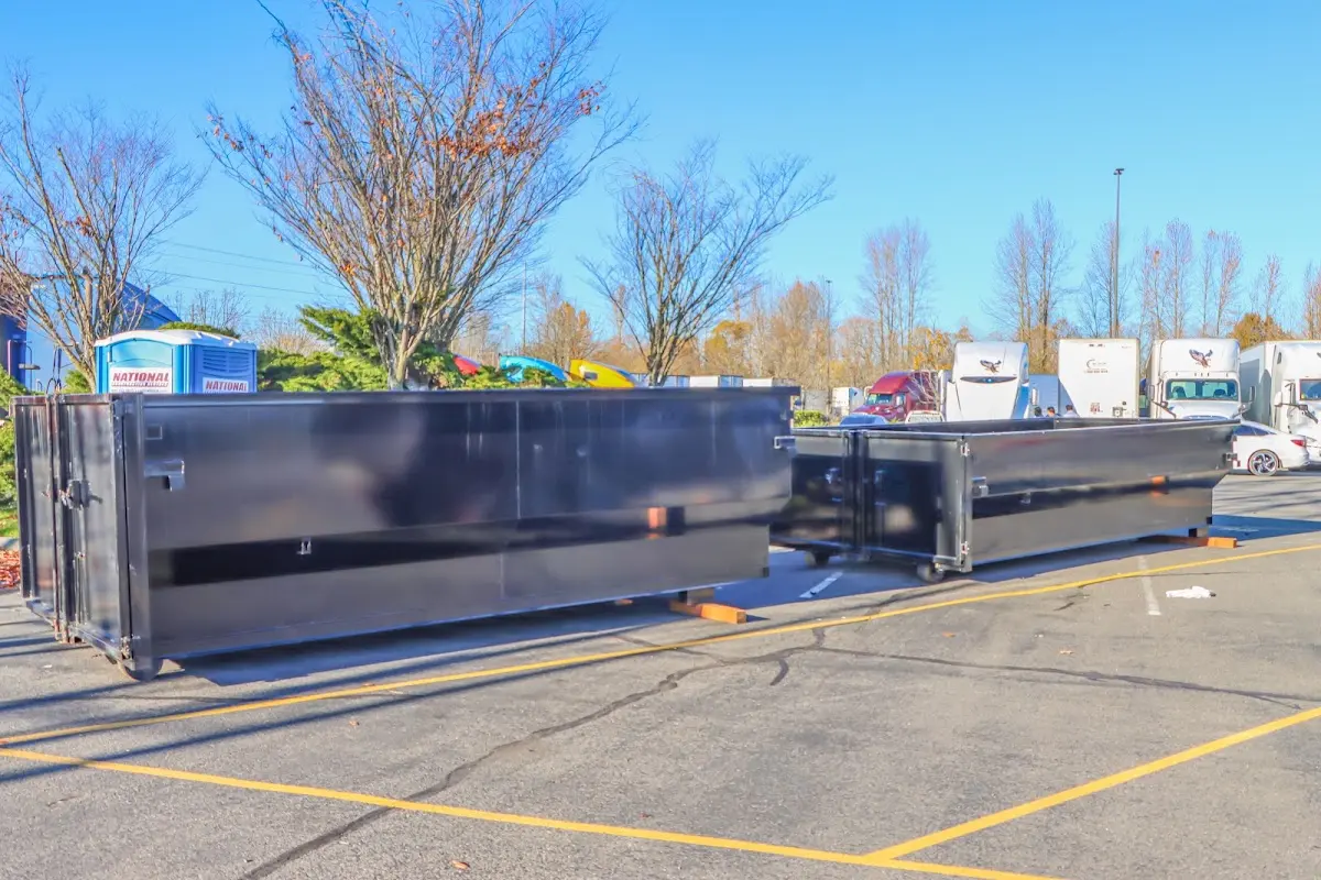 Professional dumpster rental service with roll-off container on residential driveway in Brooklyn